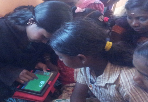 Children from tribal areas of Wayanad using 'Aksharamala' developed by Amrita CREATE on tablet